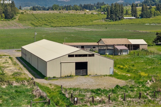 view of pole building featuring an exterior structure and a rural view