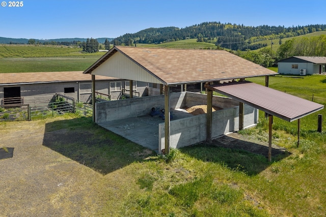 view of property's community featuring an outbuilding, an exterior structure, and a mountain view