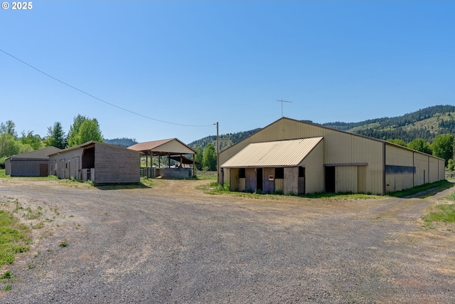 exterior space featuring an outbuilding and metal roof