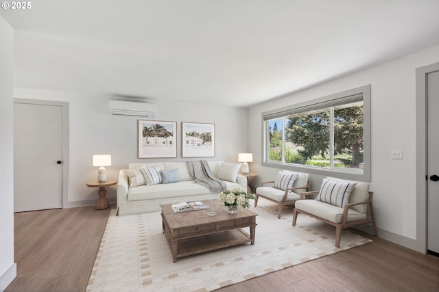 living area featuring baseboards, a wall mounted AC, and wood finished floors
