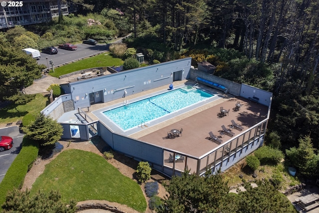 aerial view of property and surrounding area with a pool area