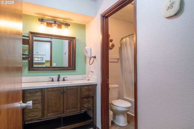 bathroom featuring toilet and vanity