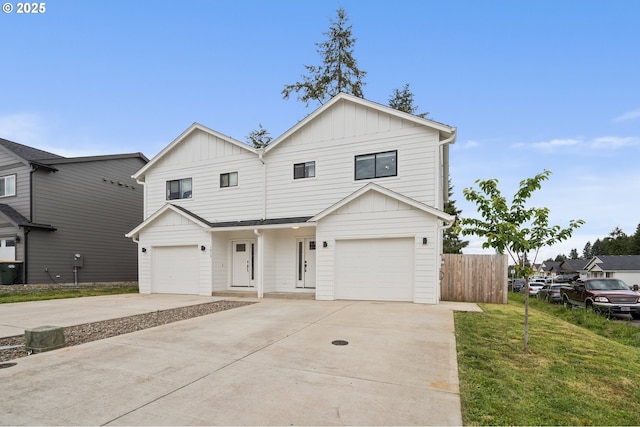 1013 Peach Rd, Winlock, WA 98596 - view of front facade with board and batten siding, an attached garage, and concrete driveway