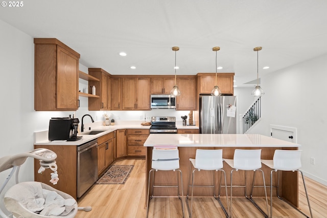 1013 Peach Rd, Winlock, WA 98596 - kitchen with stainless steel appliances, a sink, open shelves, light wood finished floors, and a kitchen island
