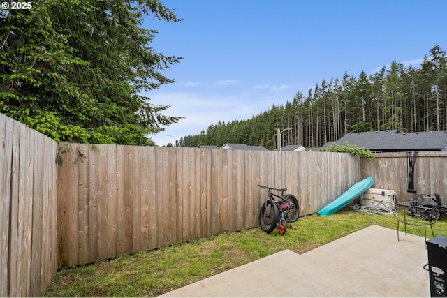 1013 Peach Rd, Winlock, WA 98596 - fenced backyard featuring a patio area and a wooded view