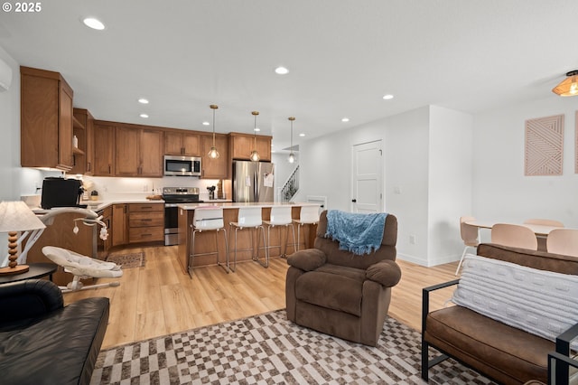 1013 Peach Rd, Winlock, WA 98596 - kitchen featuring appliances with stainless steel finishes, open floor plan, recessed lighting, light countertops, and a breakfast bar area