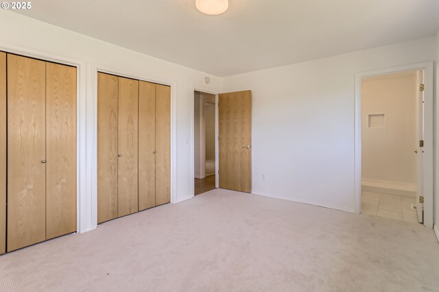 7471 SW Woodbury Loop, Wilsonville, OR 97070 - unfurnished bedroom featuring multiple closets and carpet flooring