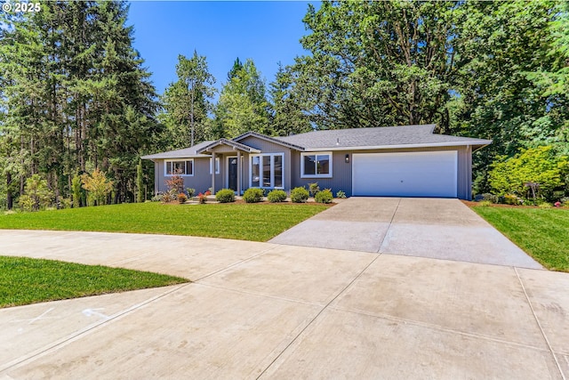 7471 SW Woodbury Loop, Wilsonville, OR 97070 - view of front of house with concrete driveway, a garage, and a front lawn