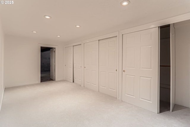 7471 SW Woodbury Loop, Wilsonville, OR 97070 - unfurnished bedroom with multiple closets, light colored carpet, and recessed lighting