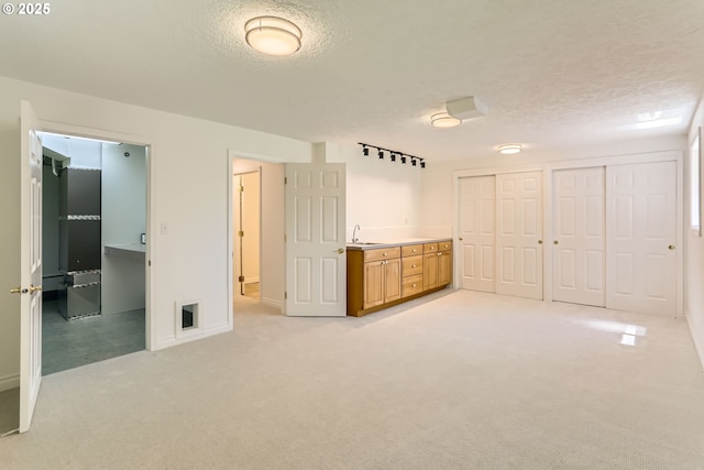 7471 SW Woodbury Loop, Wilsonville, OR 97070 - unfurnished bedroom with light carpet, a textured ceiling, and two closets