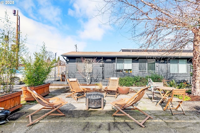 view of patio / terrace featuring an outdoor fire pit