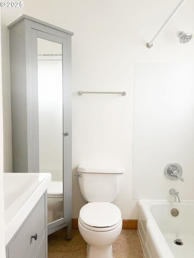 bathroom with vanity, toilet, baseboards, and shower / bath combination