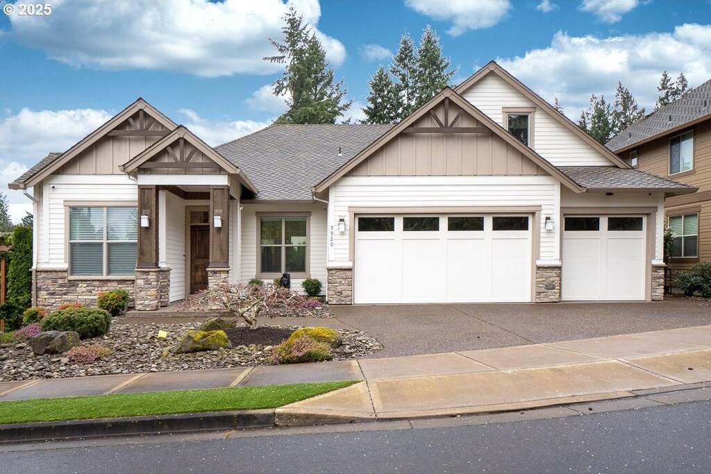 9920 SW Iowa Dr, Tualatin, OR 97062 - craftsman-style home with board and batten siding, an attached garage, stone siding, and driveway