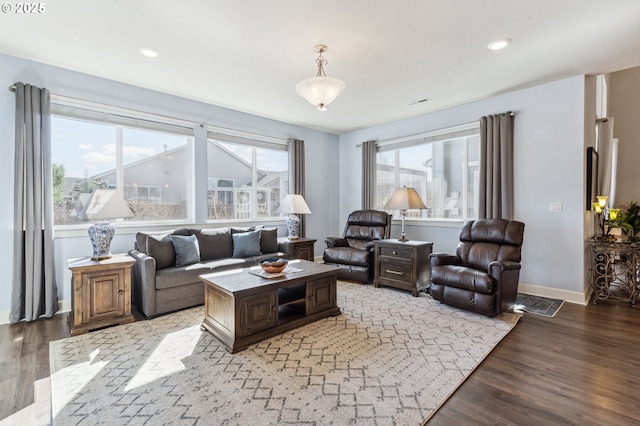 living area with light wood-type flooring, visible vents, baseboards, and recessed lighting