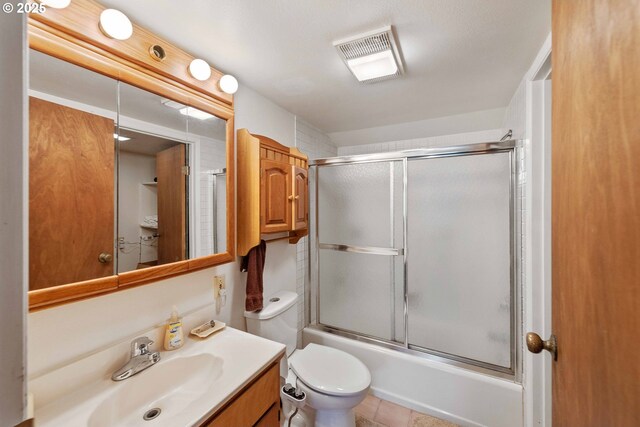 91256 Cape Arago Hwy, Coos Bay, OR 97420 - bathroom with vanity, toilet, and shower / bath combination with glass door