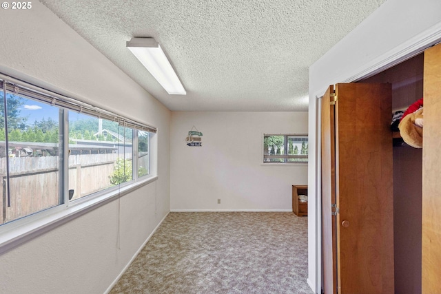 91256 Cape Arago Hwy, Coos Bay, OR 97420 - unfurnished room with carpet, a textured ceiling, and baseboards