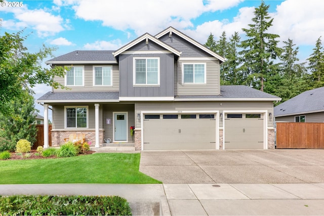 craftsman house featuring a garage and a front lawn