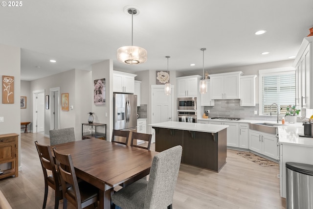 dining room featuring sink and light hardwood / wood-style flooring