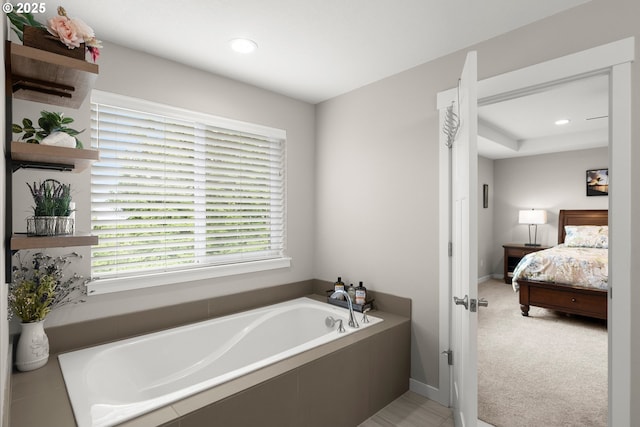 bathroom featuring a relaxing tiled tub