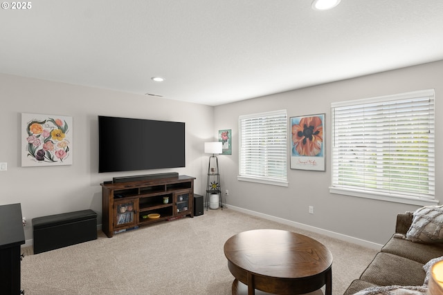 living room featuring light carpet and a wealth of natural light