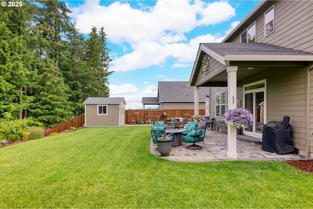 view of yard featuring a patio and a storage shed