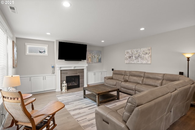 living room with a fireplace and light hardwood / wood-style flooring