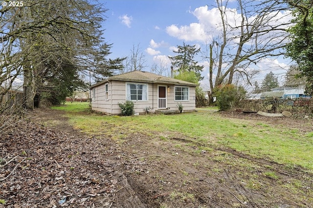 bungalow-style house featuring a front yard