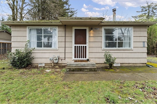 view of front facade with a front lawn and crawl space