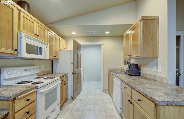 kitchen with light brown cabinetry, lofted ceiling, sink, and white appliances