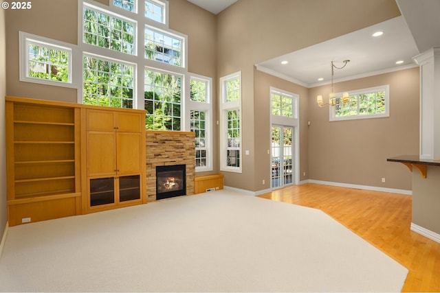7917 NW Blue Pointe Ln, Portland, OR 97229 - living area with light wood-style floors, recessed lighting, baseboards, a chandelier, and crown molding