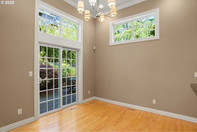 7917 NW Blue Pointe Ln, Portland, OR 97229 - unfurnished room with a chandelier, plenty of natural light, and baseboards