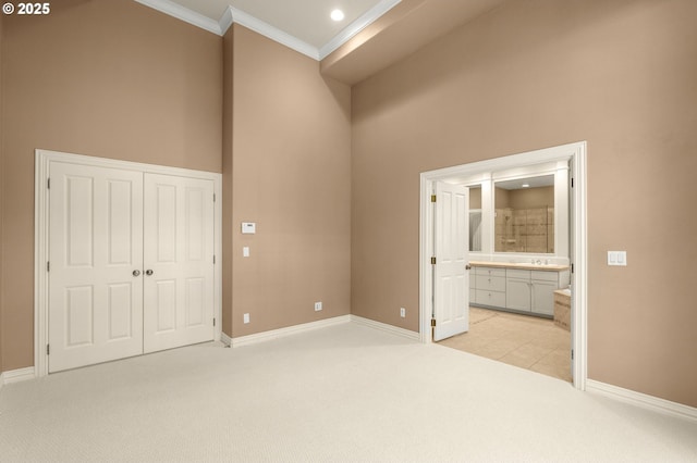 7917 NW Blue Pointe Ln, Portland, OR 97229 - unfurnished bedroom featuring ornamental molding, light carpet, baseboards, a closet, and connected bathroom