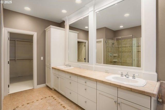 7917 NW Blue Pointe Ln, Portland, OR 97229 - full bath with tile patterned flooring, a stall shower, double vanity, a walk in closet, and recessed lighting