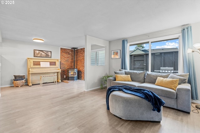 251 NE Village Squire Ave Unit 2, Gresham, OR 97030 - living room featuring a wood stove and light wood-style flooring