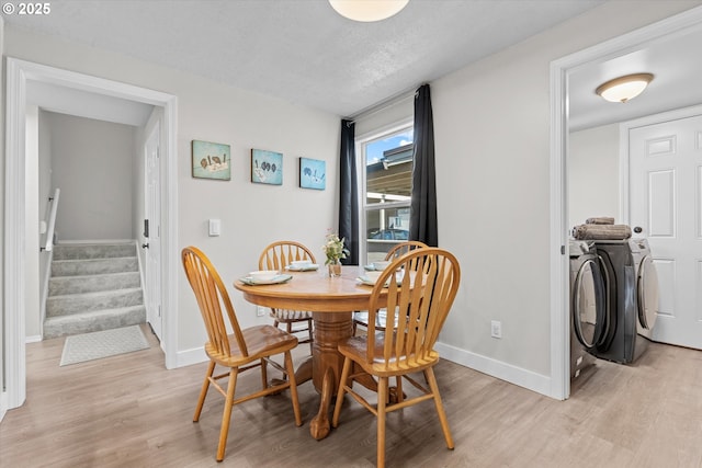 251 NE Village Squire Ave Unit 2, Gresham, OR 97030 - dining room with light wood finished floors, separate washer and dryer, stairway, and a textured ceiling