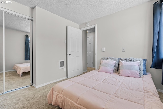 251 NE Village Squire Ave Unit 2, Gresham, OR 97030 - bedroom with carpet flooring, a closet, and a textured ceiling