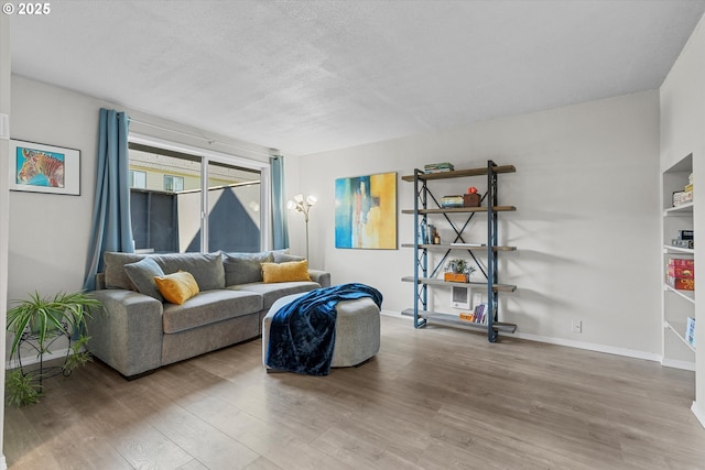 251 NE Village Squire Ave Unit 2, Gresham, OR 97030 - living area featuring wood finished floors and a textured ceiling