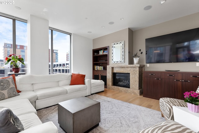 1001 NW Lovejoy St Unit 710, Portland, OR 97209 - living area with light wood-style flooring, a high end fireplace, and a view of city