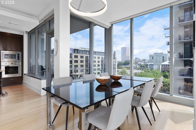 1001 NW Lovejoy St Unit 710, Portland, OR 97209 - dining space with a city view and light wood-type flooring