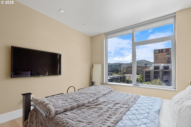 1001 NW Lovejoy St Unit 710, Portland, OR 97209 - bedroom with a view of city, wood finished floors, and recessed lighting