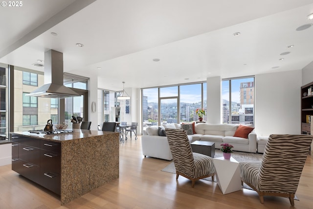 1001 NW Lovejoy St Unit 710, Portland, OR 97209 - living area with light wood finished floors, a city view, and floor to ceiling windows