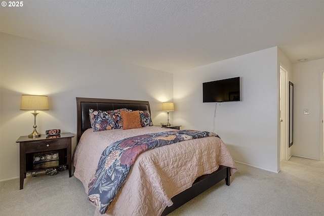 carpeted bedroom featuring a textured ceiling