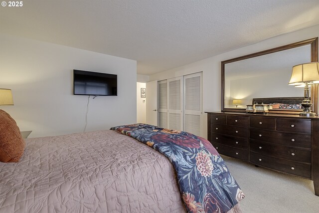 carpeted bedroom featuring a closet and a textured ceiling