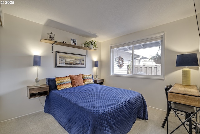 bedroom featuring light colored carpet and a textured ceiling