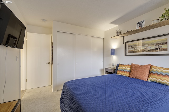 carpeted bedroom with a closet