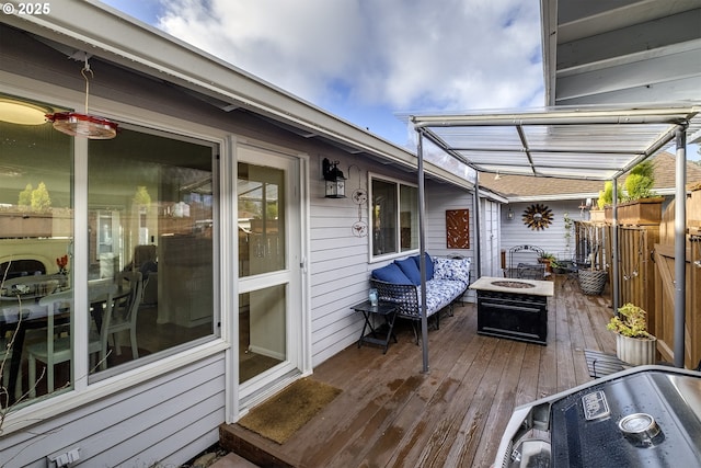 deck featuring a pergola and an outdoor fire pit