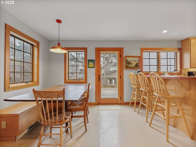 dining room featuring baseboards, recessed lighting, and finished concrete floors