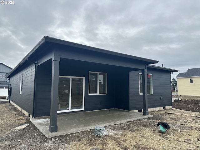 view of side of property with a patio area