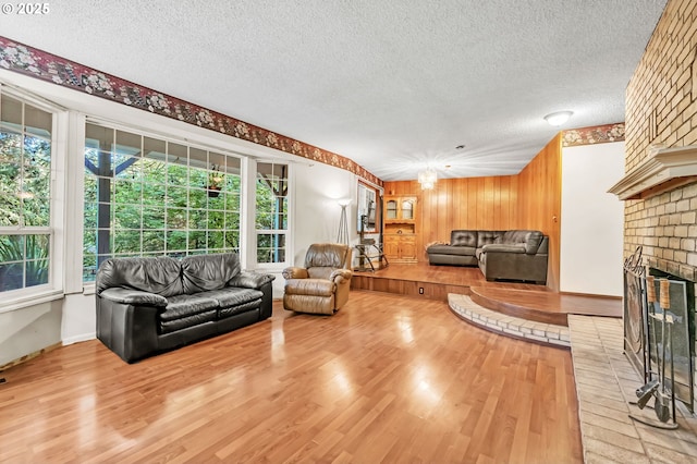 32739 Taylor Butte Rd, Cottage Grove, OR 97424 - living area featuring a textured ceiling, light wood-style flooring, and a brick fireplace