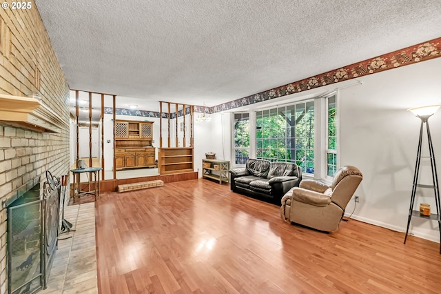 32739 Taylor Butte Rd, Cottage Grove, OR 97424 - living room featuring a textured ceiling, light wood-style flooring, and a brick fireplace